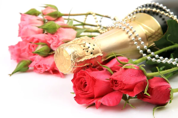 Champagne bottle and roses — Stock Photo, Image