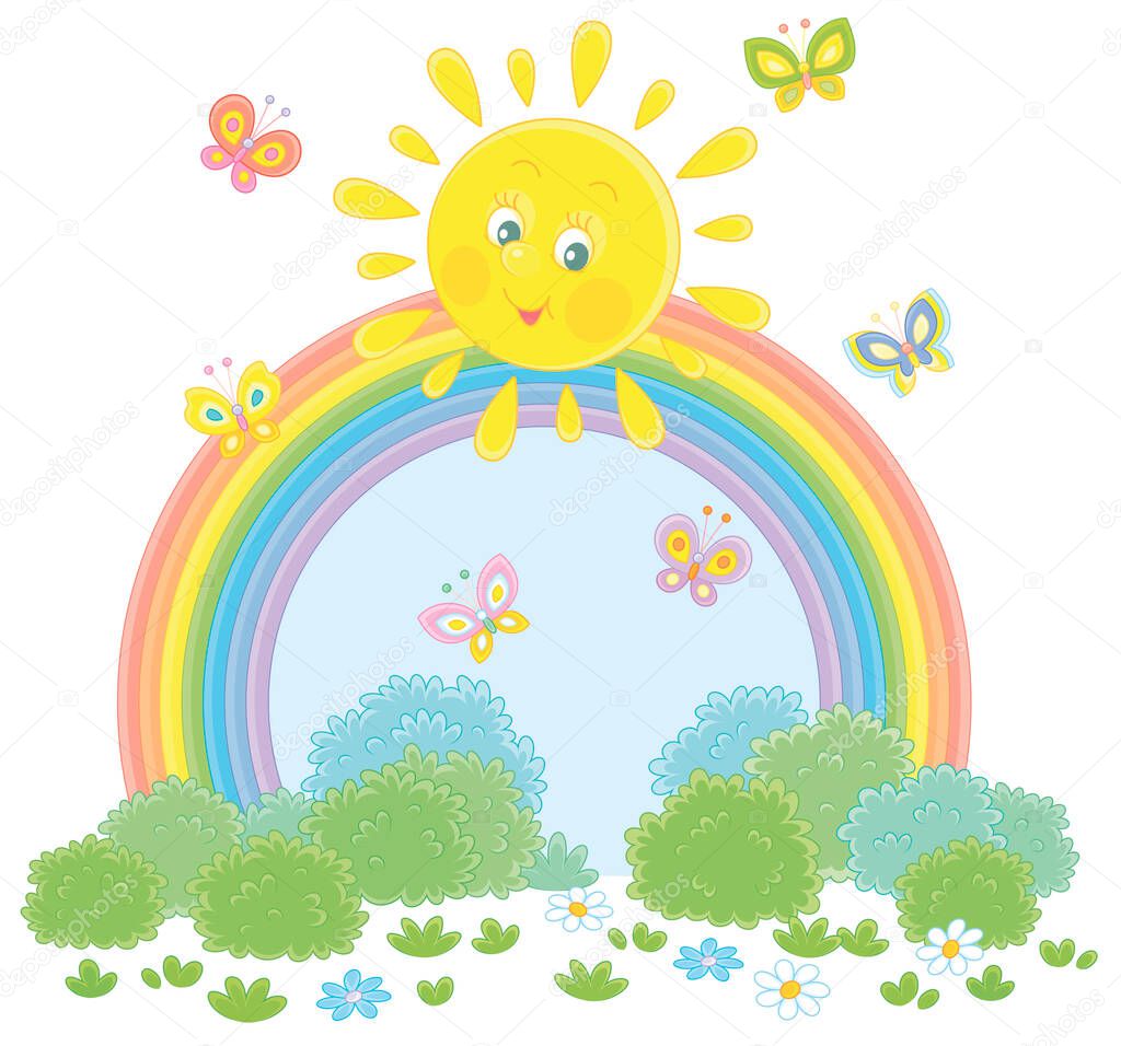 Friendly smiling sun with a colorful rainbow and butterflies merrily flittering over a green field with flowers and green bushes after warm summer rain, vector cartoon illustration