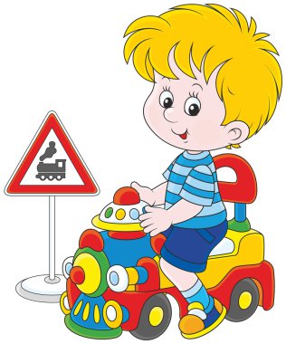 Çocuk bir oyuncak tren üzerinde