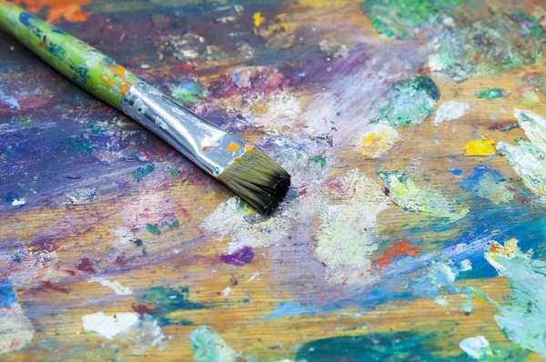 Brush on colorful  pallet — Stock Photo, Image