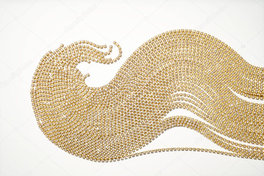 Strass strands on a white background, beautifully laid out in waves.