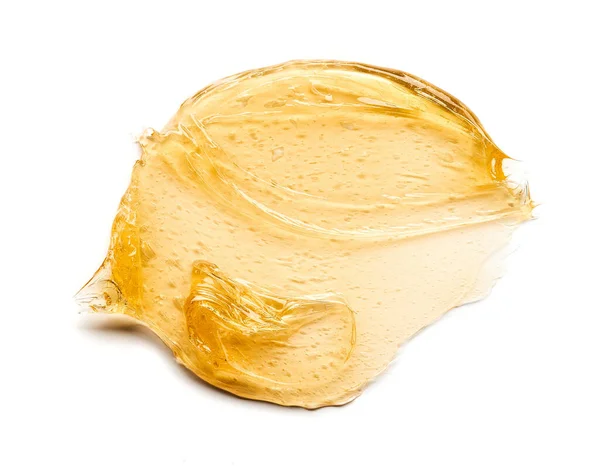 透明的黄色涂抹面霜或金黄色蜂蜜分离的白色背景 白色背景上的金色乳白色质感 — 图库照片