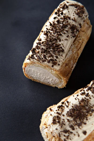 Exquisite cream dessert eclair — Stock Photo, Image