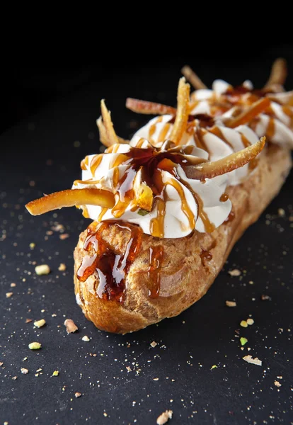 Exquisite cream dessert eclair — Stock Photo, Image