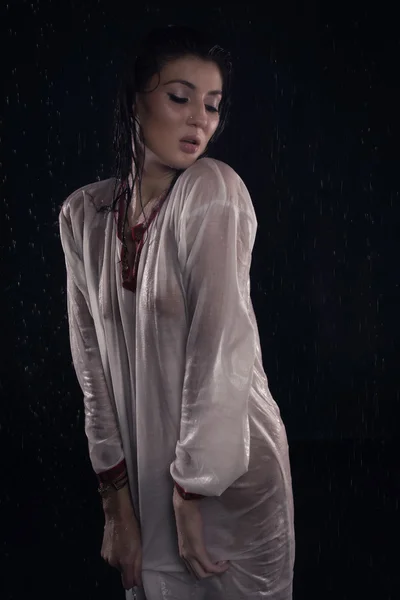 Brunette girl under water drops