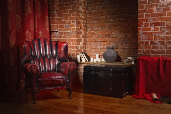 Antique chair against a brick wall — Stock Photo, Image