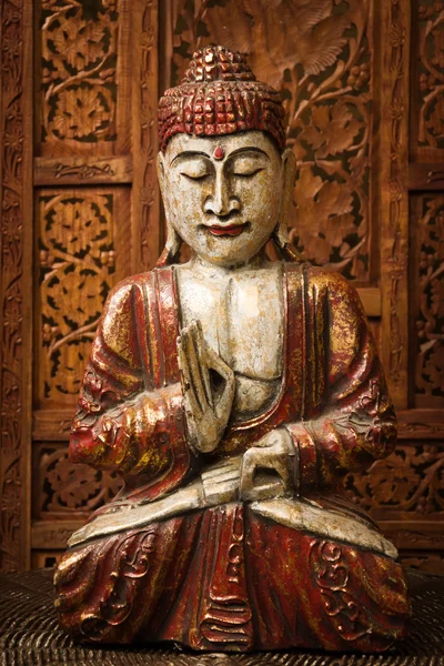 Bronze figurine of the Buddha at the room interior. — Stock Photo, Image
