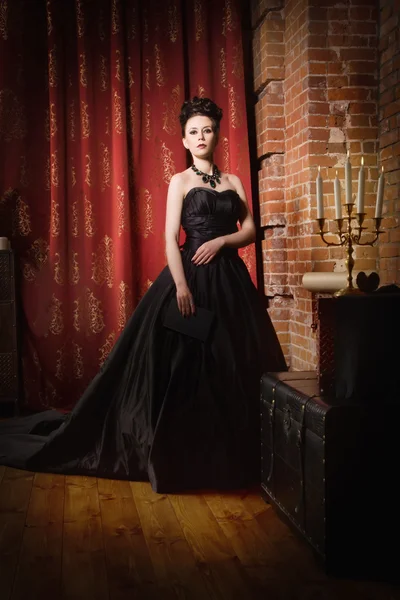 Sensual gothic woman in a long gorgeous black dress — Stock Photo, Image