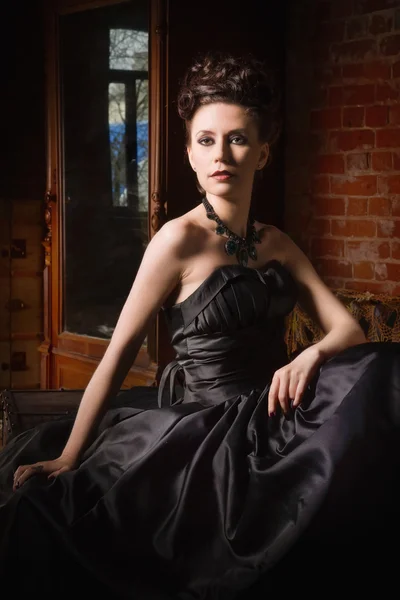 Sensual gothic woman in a long gorgeous black dress — Stock Photo, Image