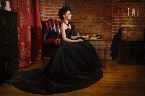 Sensual gothic woman in a long gorgeous black dress — Stock Photo, Image