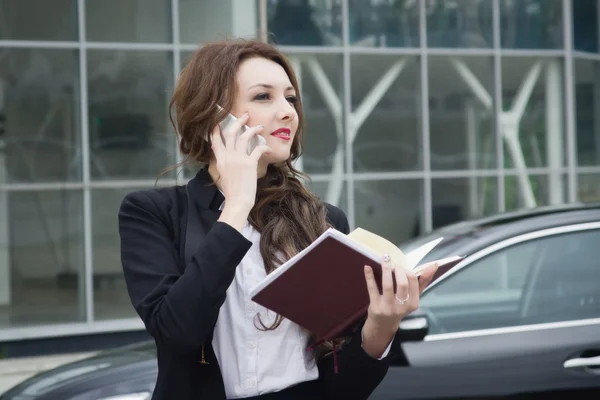Mujer de negocios en el teléfono de pie en la calle coche de fondo —  Fotos de Stock