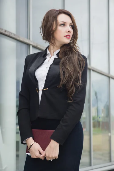 Attractive business woman in suit on a street — Stock Photo, Image