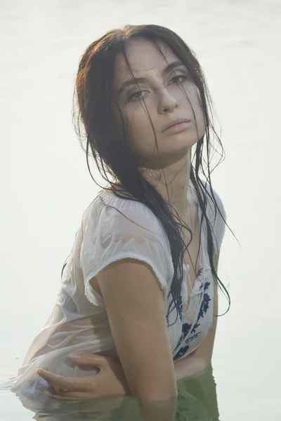 Sexy woman in white shirt posing on the forest lake — Stock Photo, Image