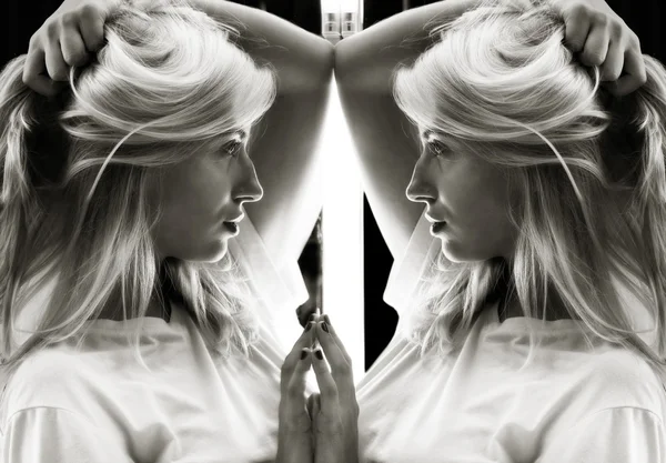 Sexy girl in white t-shirt and her reflection in mirror table — Stock Photo, Image