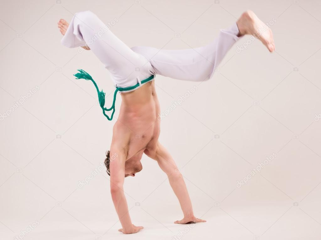 Capoeira dancer on white background