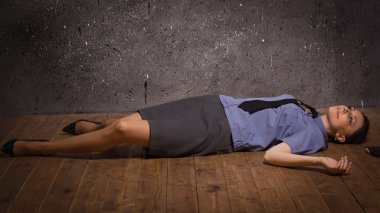 Woman police officer lying on a floor clipart
