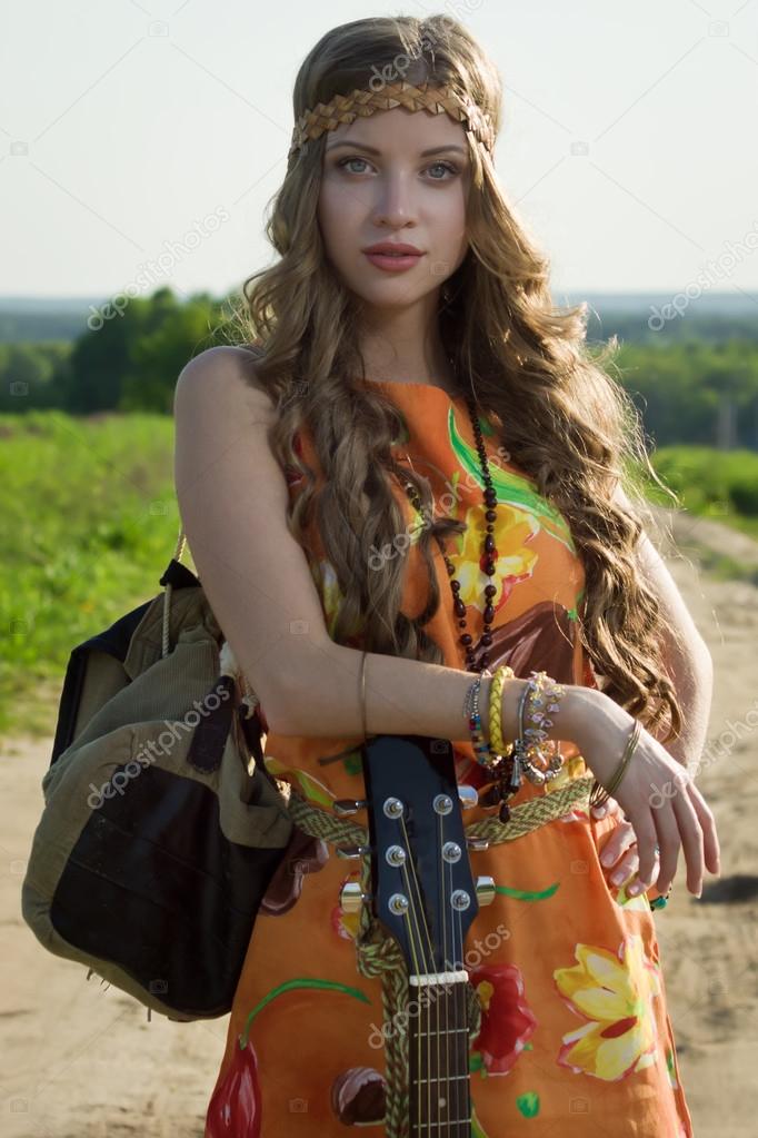 Attractive girl travelling with her guitar