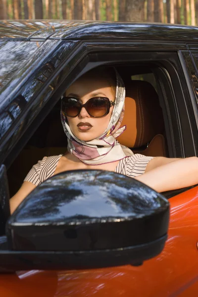 Fashion  woman behind steering wheel — Stock Photo, Image