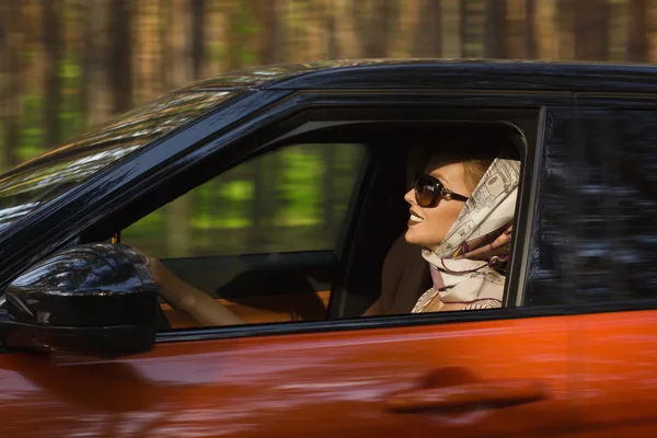 Fashion  woman behind steering wheel — Stock Photo, Image