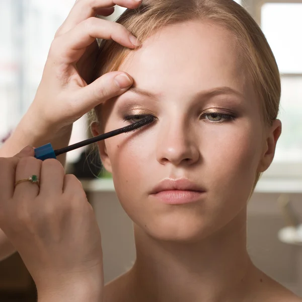 Make-up artist applying liquid eyeliner with brush Stock Photo