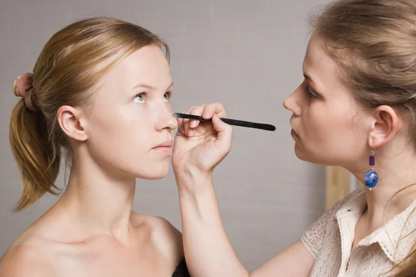 Make-up artist tillämpa flytande eyeliner med borste — Stockfoto