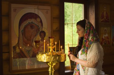 Russian woman praying in church clipart
