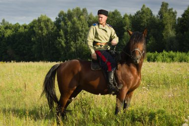 Russian Cossack inspecting the border on horseback clipart