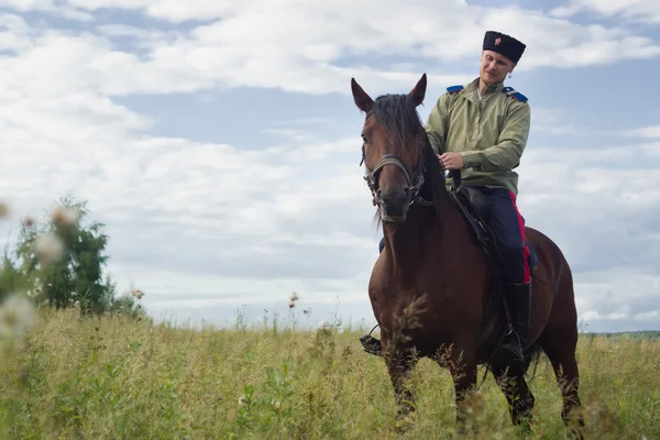 Russian Cossack inspecting the border on horseback — Stock Photo, Image