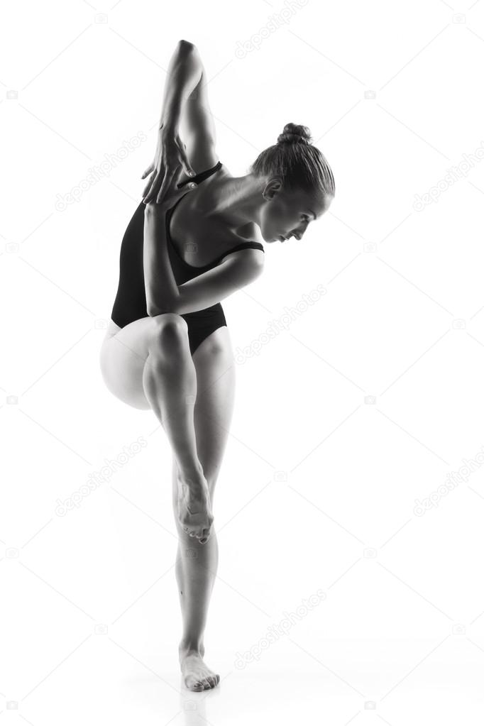 Modern ballet dancer posing on white background
