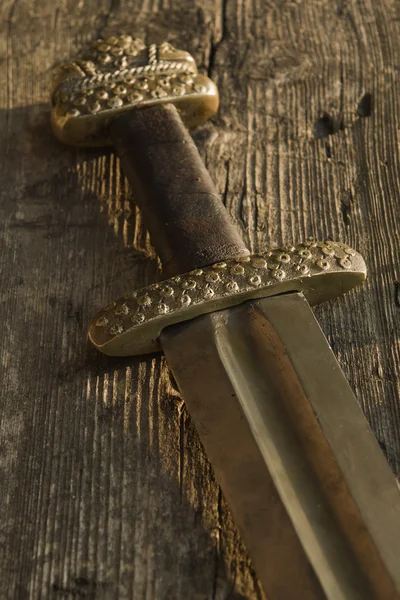 Medieval viking sword against a wooden wall — Stock Photo, Image