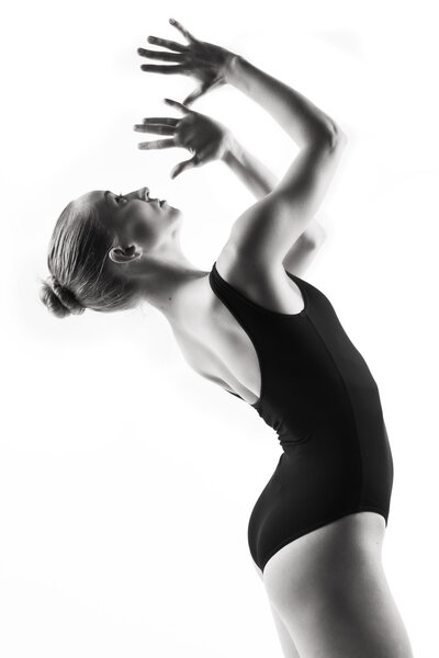 Young modern ballet dancer posing on white backgroun