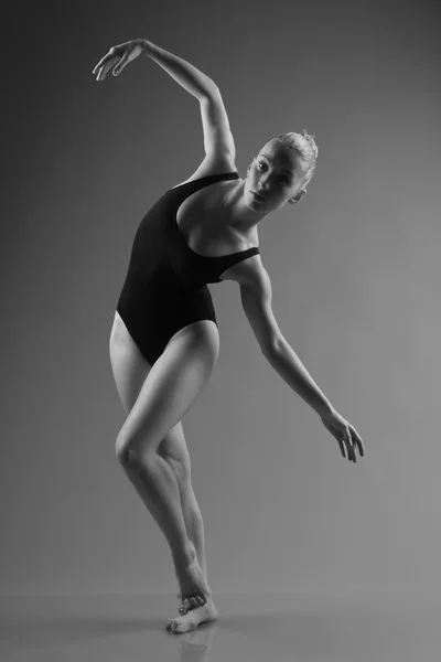 Modern ballet dancer posing on dark background — Stock Photo, Image