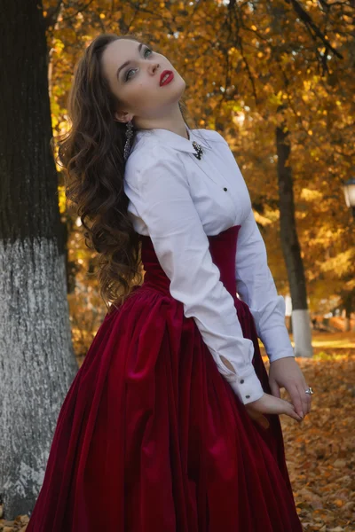 Vrouw gekleed in een retro-stijl op de herfst alley — Stockfoto