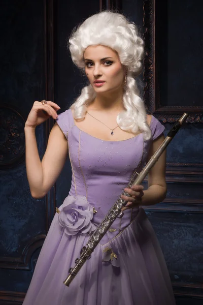 Attractive young female flautist wearing baroque dress — Stock Photo, Image