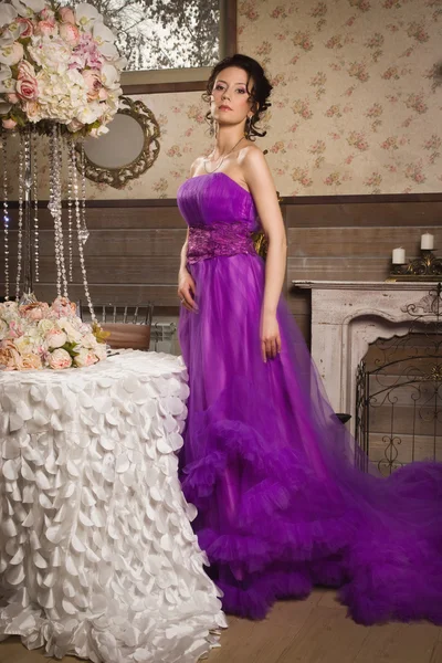 Mooie vrouw gekleed in lange kant jurk in een vintage interio — Stockfoto