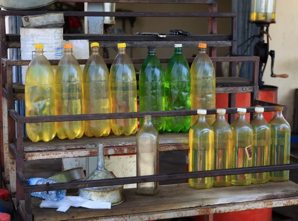 Plastic bottles with fuel on petrol station — Stock Photo, Image