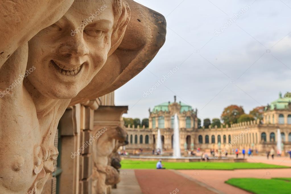 Closeup naked satyr smiling statue crop with fountain and garden