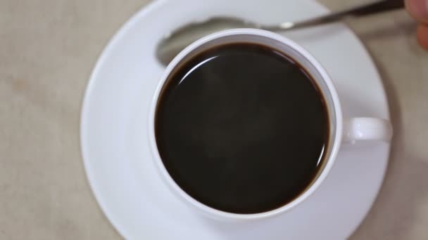 Espresso in white cup and saucer with spoon — Stock Video