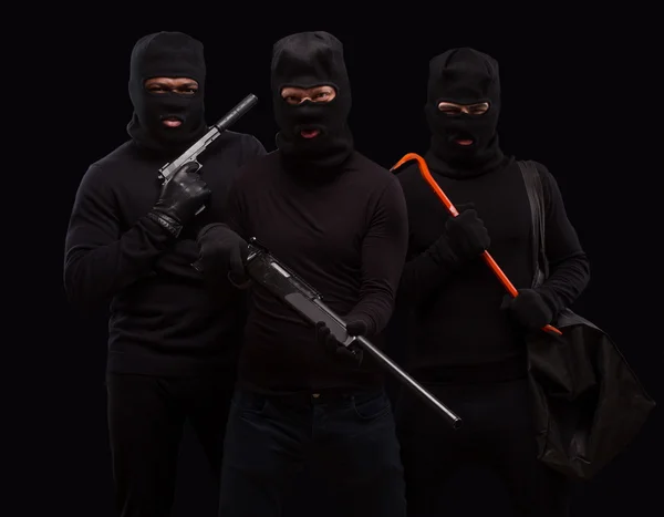 Robbers in black masks — Stock fotografie