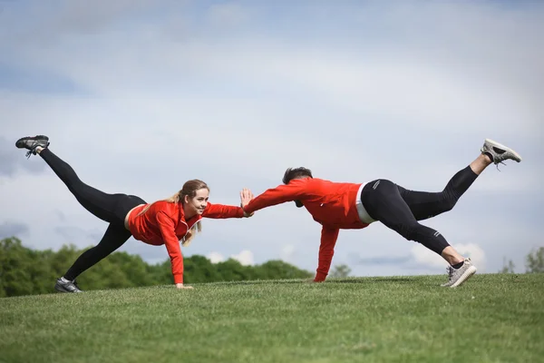 Sport man and woman training in park