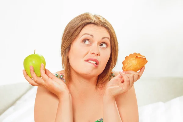 Mujer gorda sentada a la mesa en casa — Foto de Stock