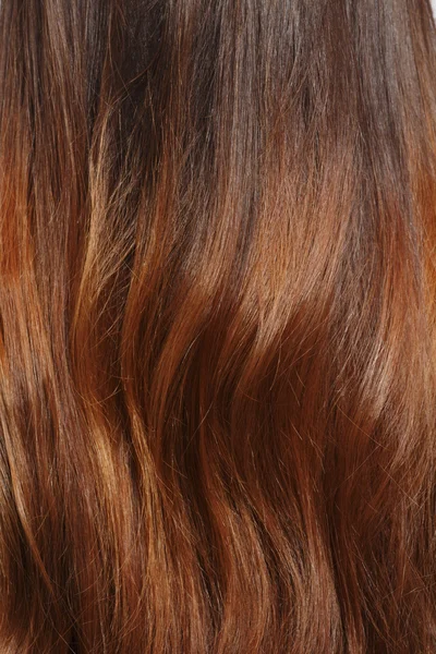 Длинные каштановые волосы в качестве фона — стоковое фото