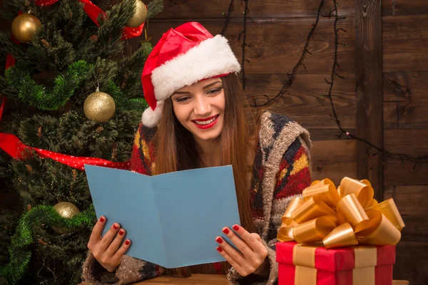 Beautiful girl reading New Year and Christmas congratulation — Stock Photo, Image