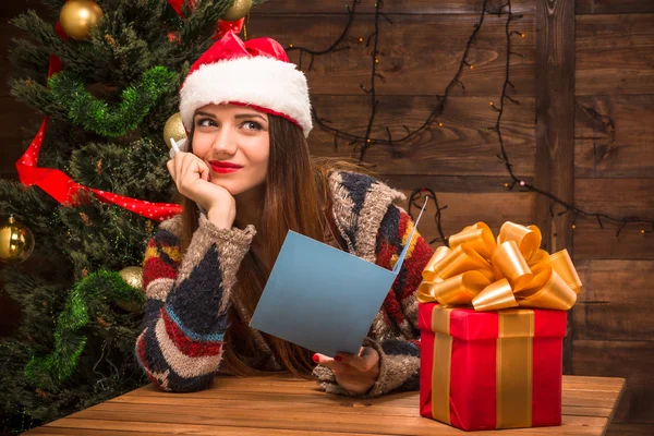 Beautiful girl holding a New Year and Christmas post card — Stock Photo, Image