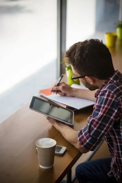 Handsome student studying in restaurant — Stock Photo, Image