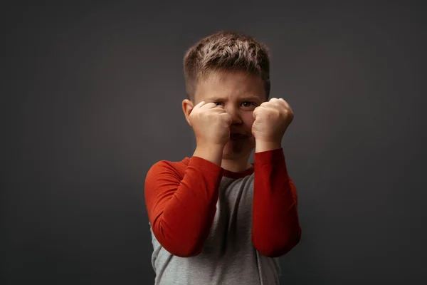 Sad preschool kid expresses anger. Little boy holds his fists in front of him to attack or defend. Conflict concept. Fight concept — Stock Photo, Image