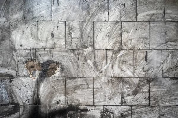 Abstract grunge background. Dirty tiles on the wall with blurry traces of soot and dust. Gray charred wall after fire — Stock Photo, Image