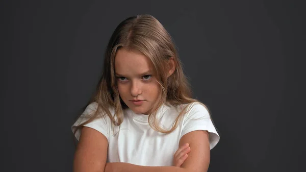 Disgruntled girl crossed her arms looking to side. Teen model expresses sad emotion. Problem concept. Close up shot. Isolated on gray background. Copy space — Stock Photo, Image