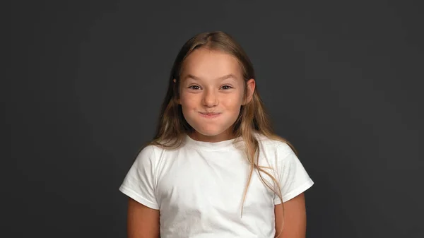 Funny teen girl puffed cheeks laughing. Emotions concept. Close up shot. Isolated on gray background. Copy space — Stock Photo, Image