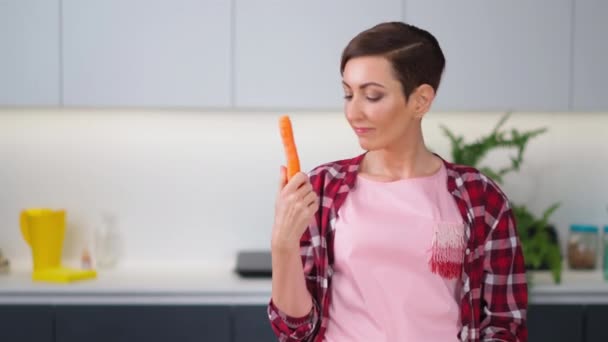 Affascinante casalinga che cucina in cucina. La scelta di carote lavate casalinga prepara torta di carote in cucina. Cibo sano a casa. Concetto di alimentazione sana — Video Stock